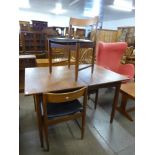 A teak extending dining table and four chairs