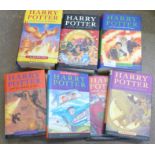 Seven Harry Potter books; three first edition and a set of four later with slipcase