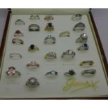 Twenty-four costume rings in a display box