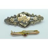A 9ct gold and garnet set brooch, 0.5g, and a silver brooch