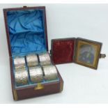A cased set of six napkin rings and a Victorian photograph, framed