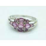 A 9ct white gold ring set with pink sapphires, 2.7g, P