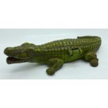 A THW cold painted cast metal novelty cigarette box in the form of a crocodile, with striker, and