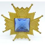 A Miriam Haskell early 1950's brooch in the form of a Maltese cross with large blue paste stone to