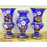 A set of three blue and gilt Bohemia glass vases