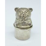 A small novelty hallmarked silver circular box depicting a bear licking a spoon