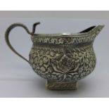 A Persian white metal cream jug