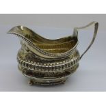 A George III white metal cream jug, 147g