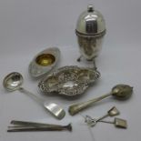 A tea strainer, embossed white metal dish, two miniature spades and other plated items