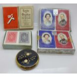 Five packs of playing cards and a compact