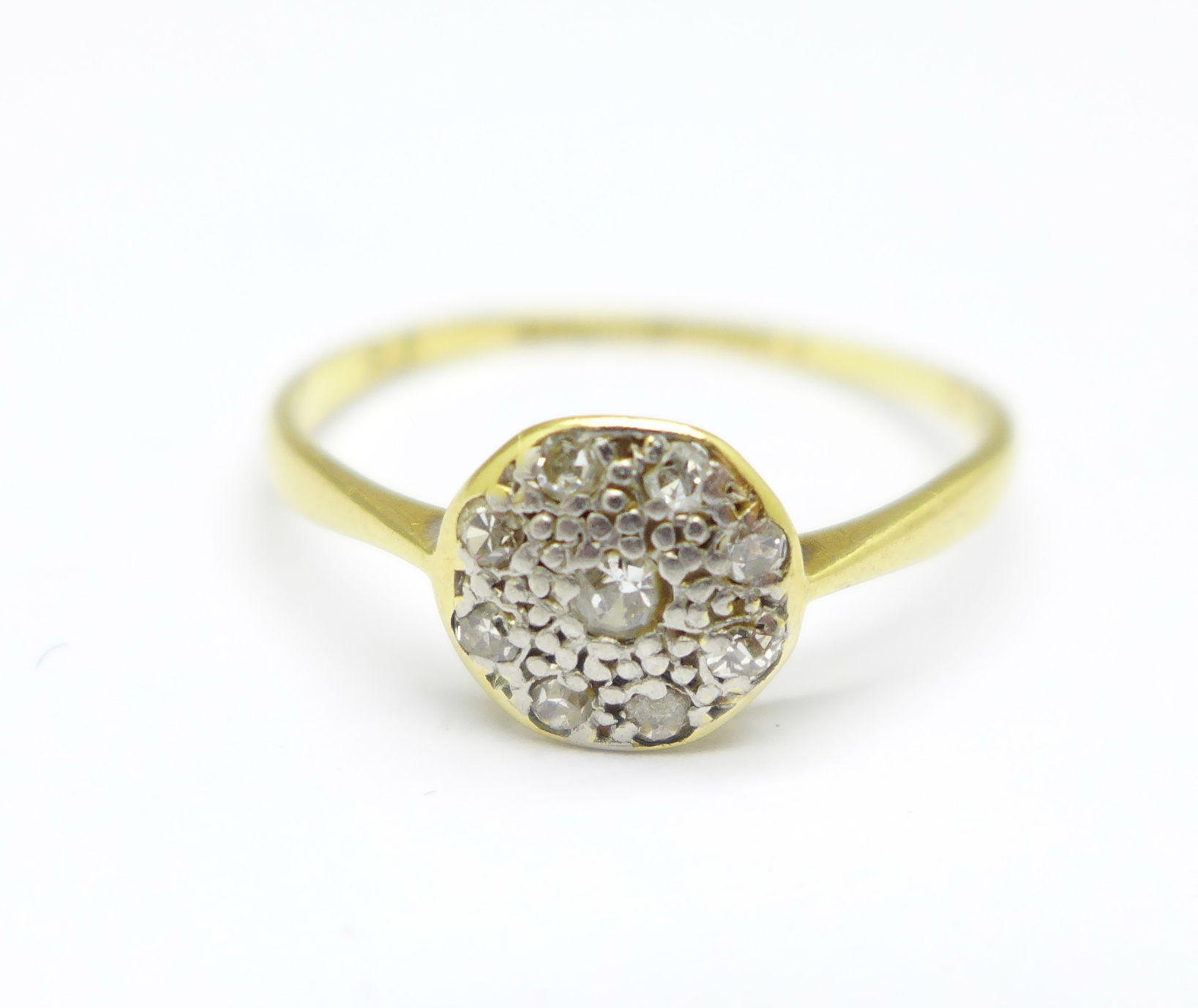 An 18ct gold, platinum set diamond cluster ring, 1.2g, L