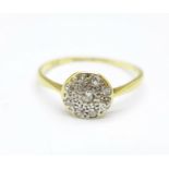 An 18ct gold, platinum set diamond cluster ring, 1.2g, L