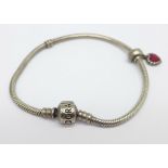 A silver Pandora bracelet with one charm