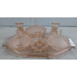 An Art Deco pink glass dressing table set
