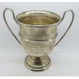 A large and good quality silver two handled trophy, with Art Nouveau twisted handles and pedestal