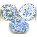 Three 18th Century Chinese porcelain plates, each with different blue painted decorations, including