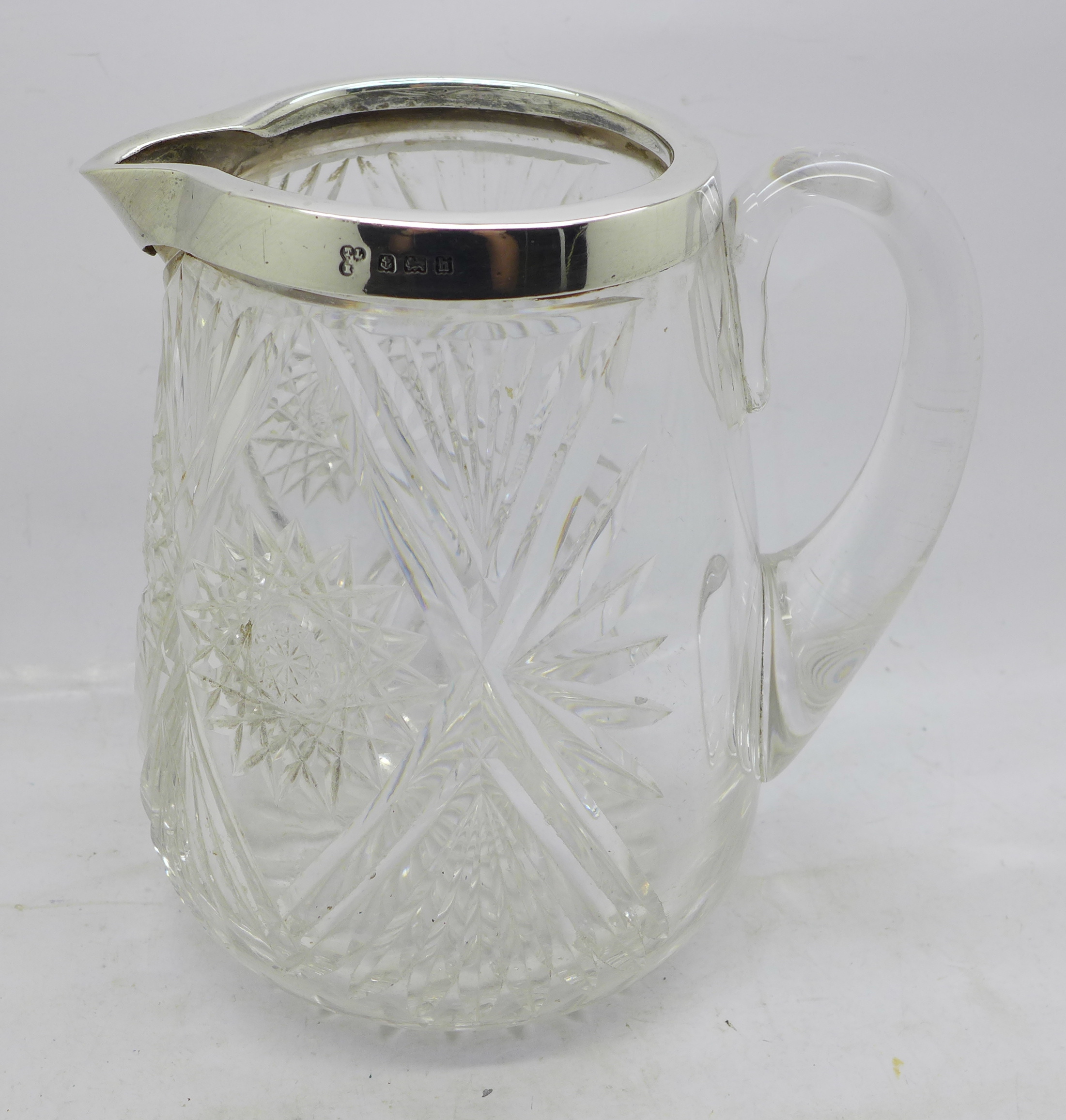 An Edward VII silver rimmed glass jug, Birmingham 1907, 15cm
