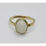 A 9ct yellow gold and moonstone ring, the cabochon cut moonstone displaying cats eye effect, in