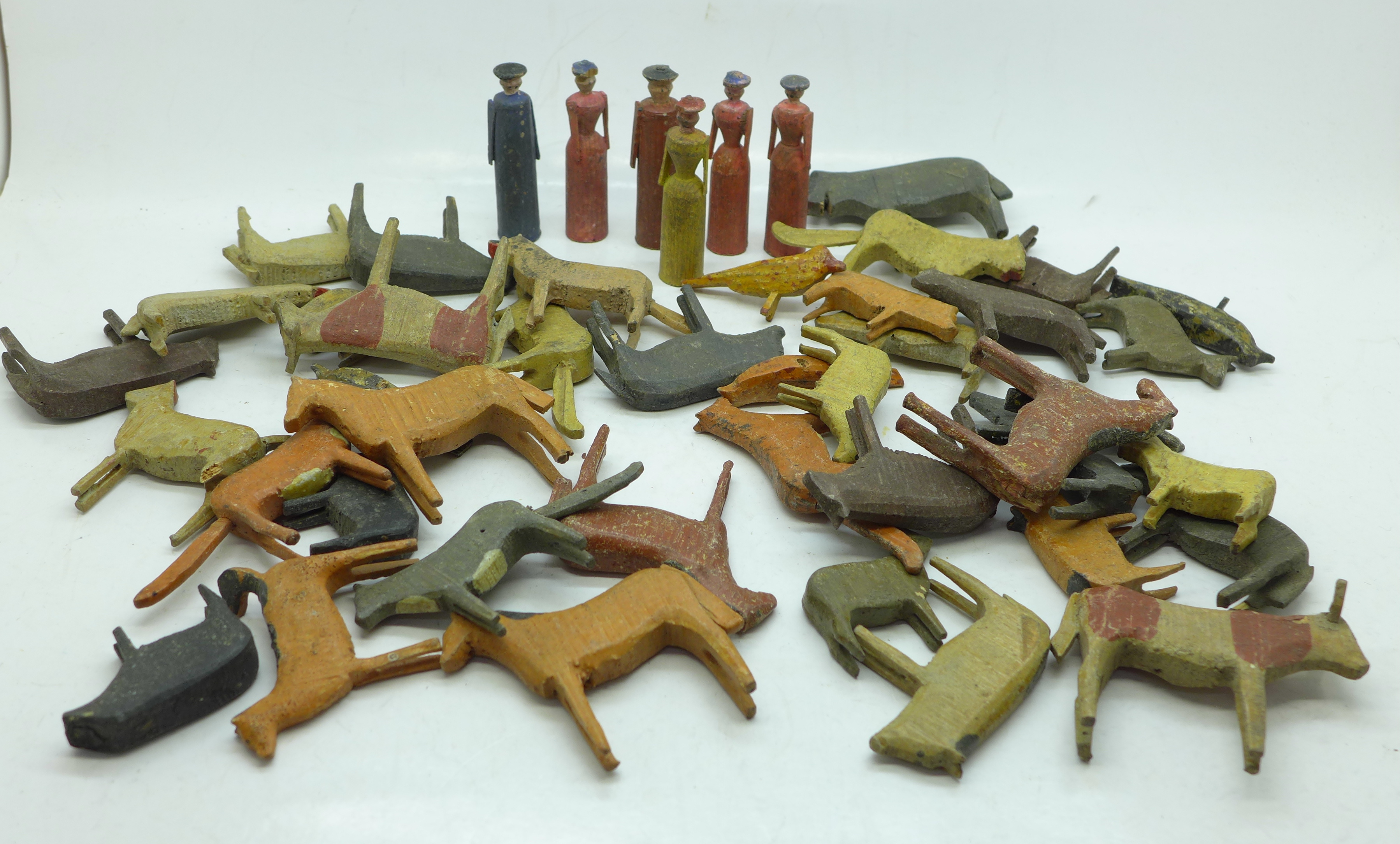 A collection of carved figures and animals, believed to be produced by WWII prisoners of war