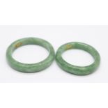 Two jade rings, his and hers, both with 9ct gold inserts inside the shanks, P and V
