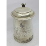 A George II style silver lidded tankard, with a shaped hinged lid and scrolled thumb piece,