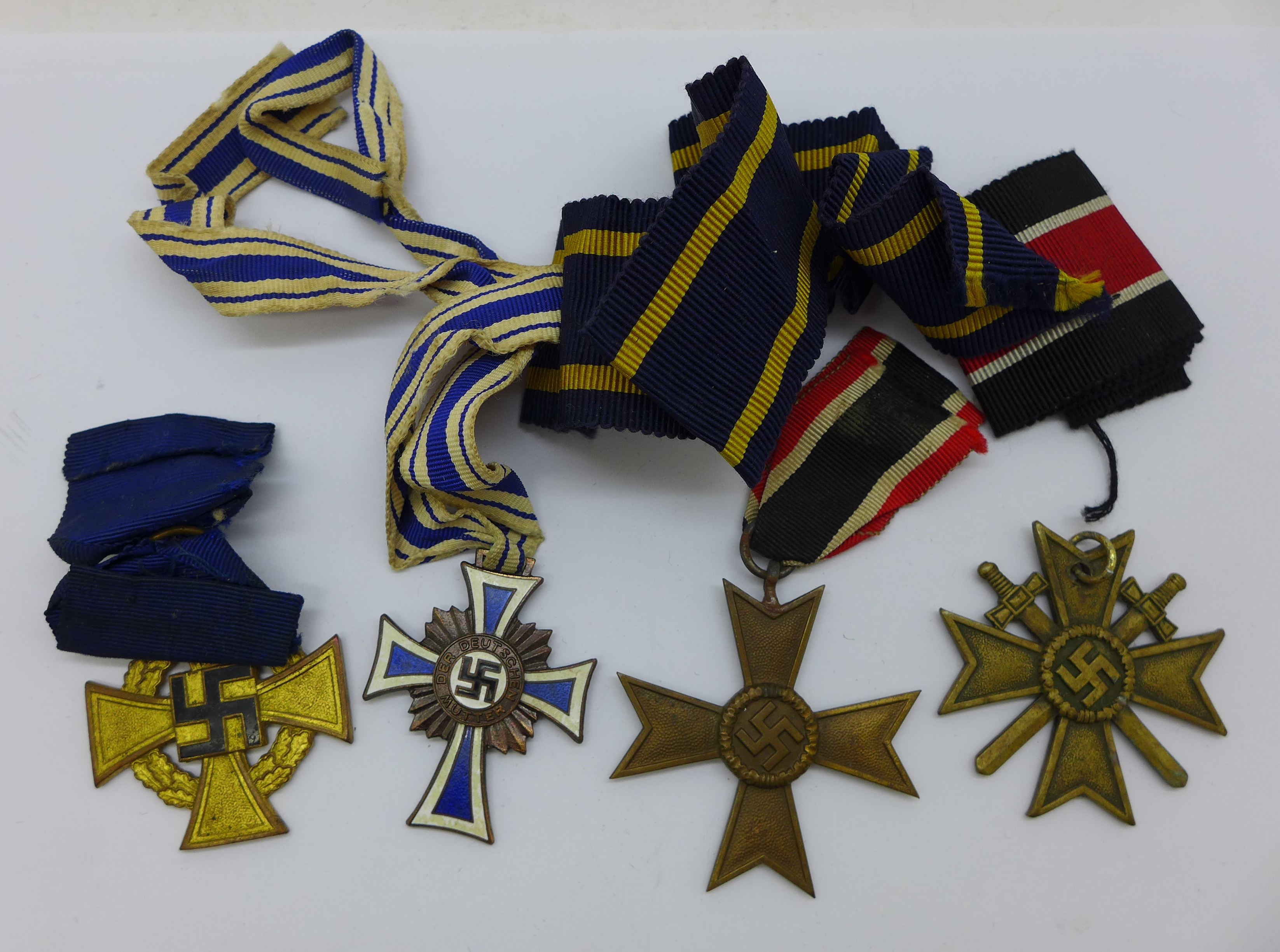 A German Mother's Cross medal and three other German military medals