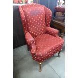 A 1930's Queen Anne style mahogany and upholstered wingback armchair