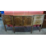 A George III inlaid Sheraton style mahogany serpentine sideboard