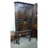 A Jacobean Revival oak geometric moulded corner cupboard on stand