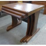 A teak and copper topped nest of tables