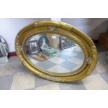 A gilt framed oval mirror