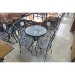 A metal and glass topped garden table and four chairs