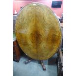 A Victorian walnut oval tilt top breakfast table