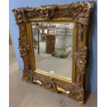 A rococo style gilt framed mirror, 94 x 82cms