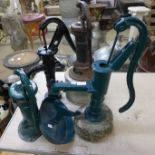 Four cast iron water pumps and a boot scraper