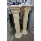 A pair of faux ivory jardiniere stands