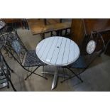 A pub table and a pair of folding metal chairs