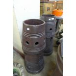 A pair of glazed terracotta chimney pots