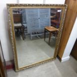 A gilt framed mirror, wicker ottoman, an Arts and Crafts bedroom chair, etc. (5)