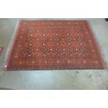 An eastern red ground rug, 212 x 158cms