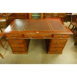 A Victorian oak and leather topped library desk