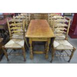 A George III style Ipswich oak eight piece dining suite, comprising gateleg dining table, six chairs