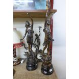 A pair of spelter figures and matching mantel clock