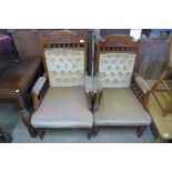 A pair of Victorian carved walnut and upholstered armchairs