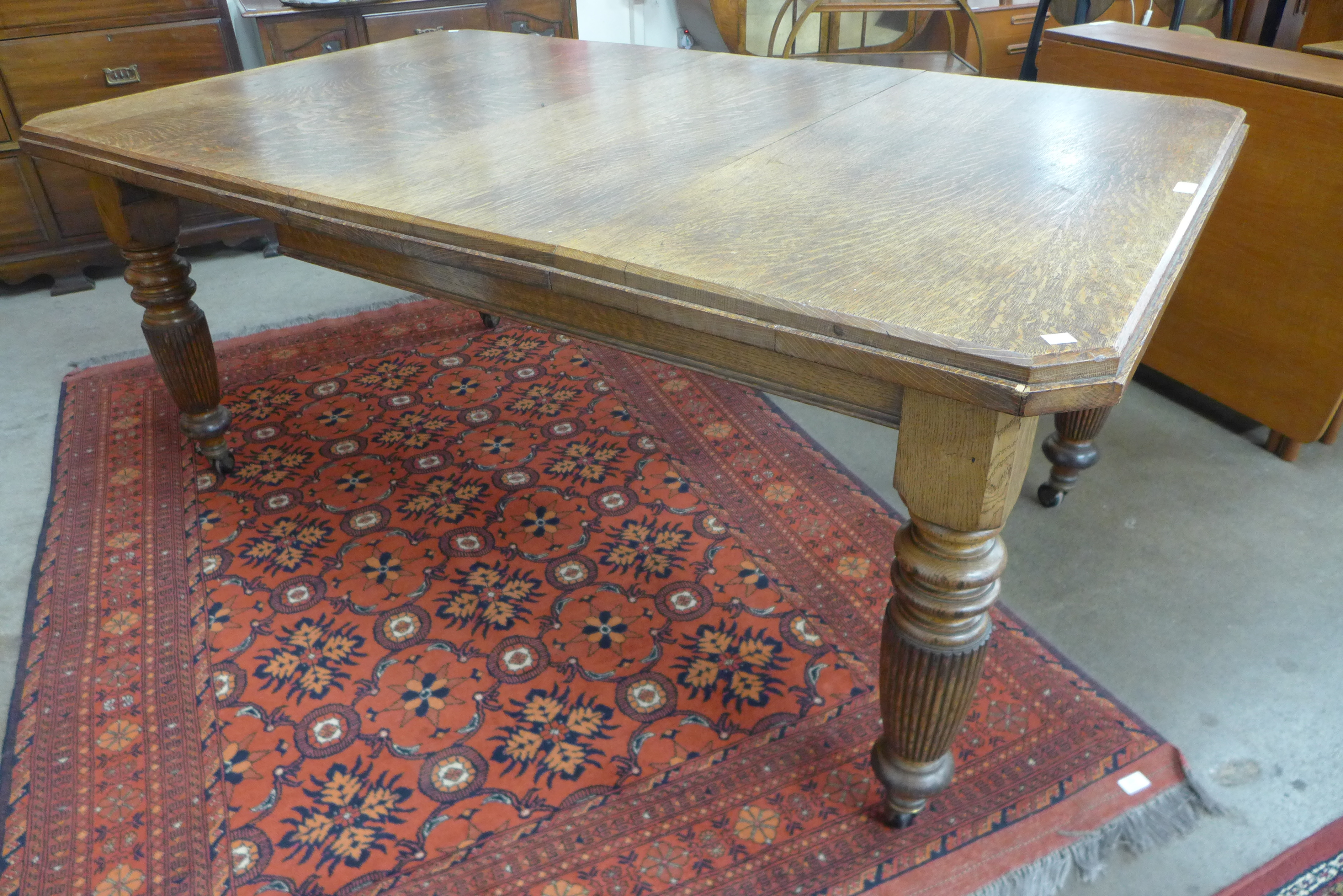 A Victorian oak extending dining table