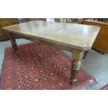 A Victorian oak extending dining table