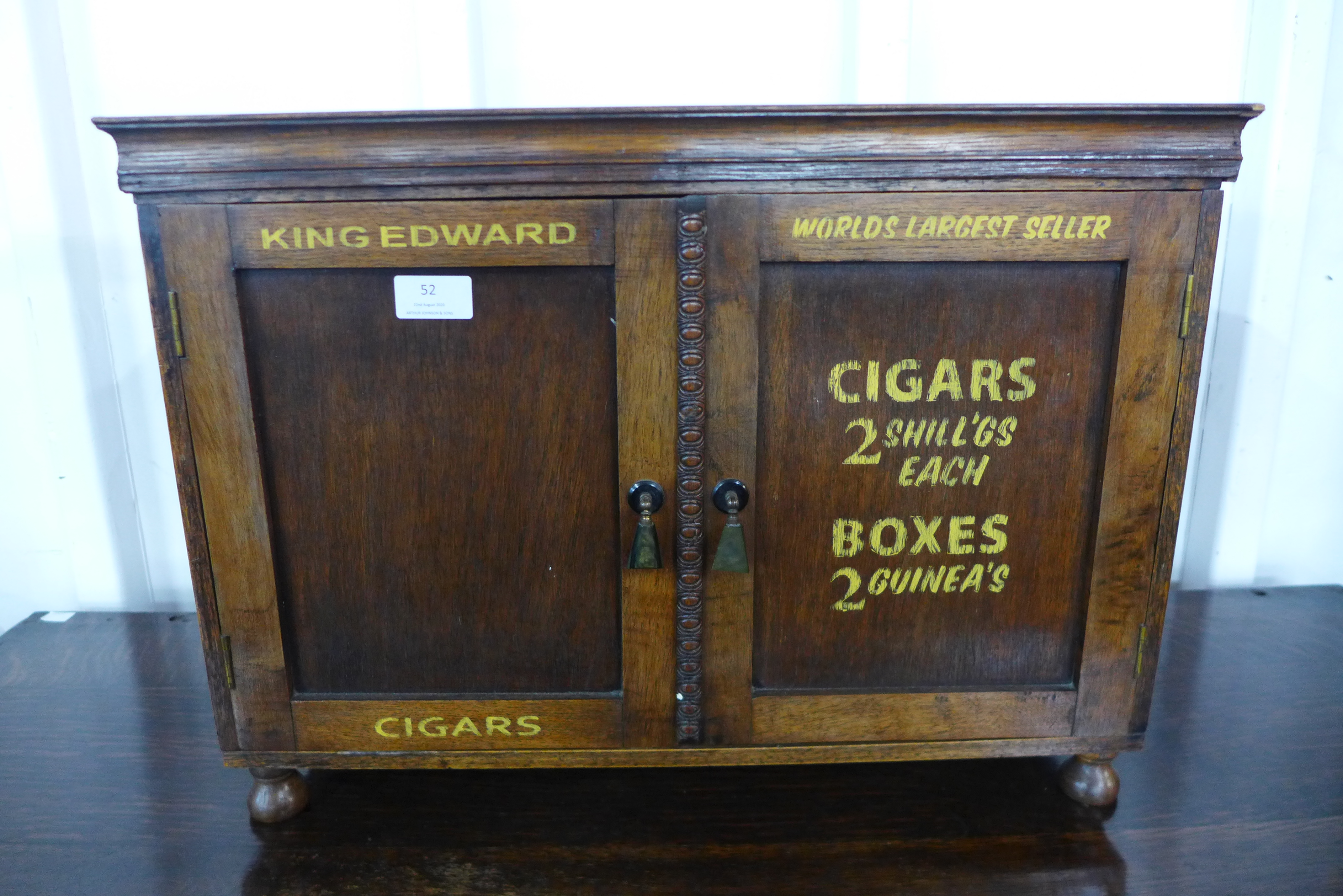 An oak table top two door cabinet, bearing painted King Edward Cigars inscription