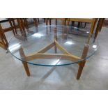 A Herbert Gibbs teak and glass topped circular coffee table