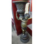 A large French style floor standing bronze cherub vase, 125cms h