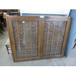 An early 20th Century pine two door clocking in card cabinet